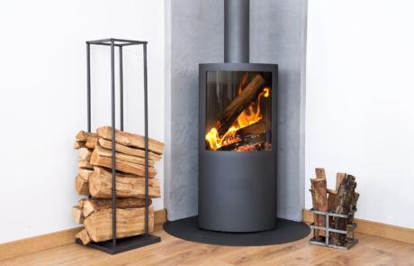 Modern burning stove next to a wood logs rack